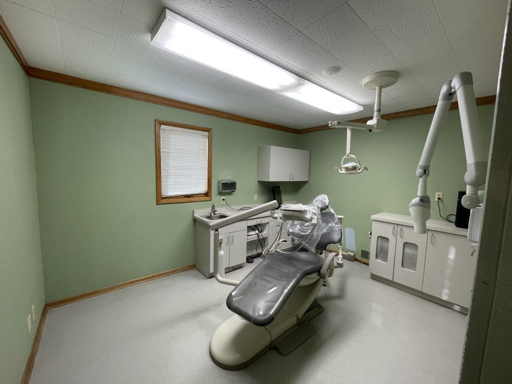 Dental chair with overhead light and x-ray machine