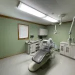 Dental chair with overhead light and x-ray machine