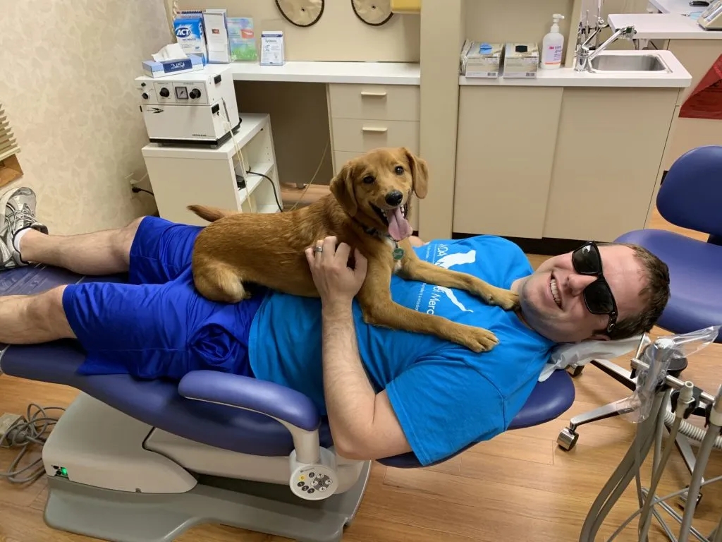 Patient in dental chair with dog