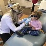 Dr. Satula examining a young girl's mouth
