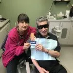 Dental hygienist with patient