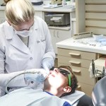 Dr. Satula using tool on patient's teeth