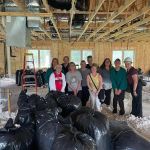 Group of people standing inside a building under construction