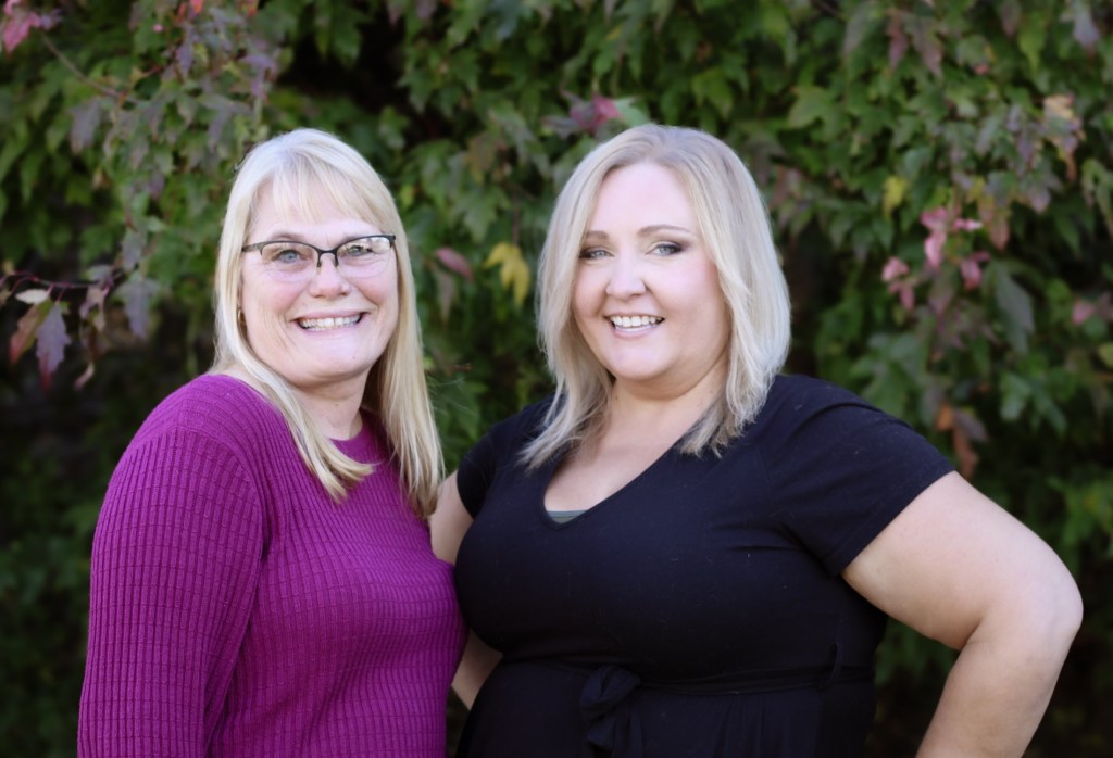 2 smiling female staff 