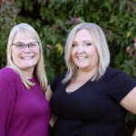 2 smiling female staff 